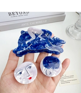 Artistic marble blue acetate hair claw set with abstract face silhouette patterns
