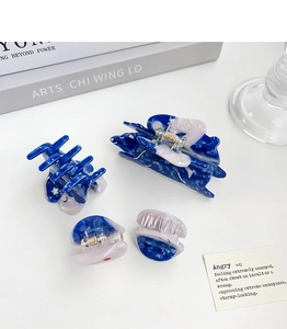 Close-up of marbled blue acetate hair claw clips set in various sizes for women