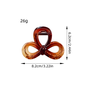 Elegant amber translucent bow-shaped hair claw clip with stylish hollow design