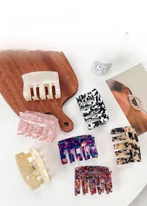 Macro view of assorted tortoiseshell and marble acetate hair claws for elegant styling