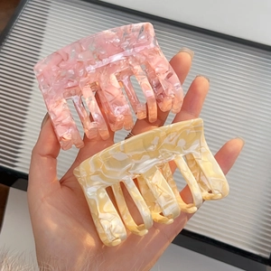 Set of two stylish acetate hair claws with pink floral and cream marble patterns