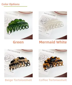 Close-up of acetic acid hair claws in green, pearl white, and tortoiseshell colors
