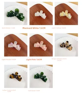 Assorted colors of 11cm and 7.6cm acetate bow hair clips in grid layout