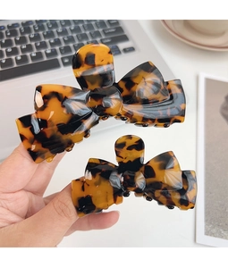 Macro shot of tortoise shell pattern texture on acetate butterfly hair claw clips