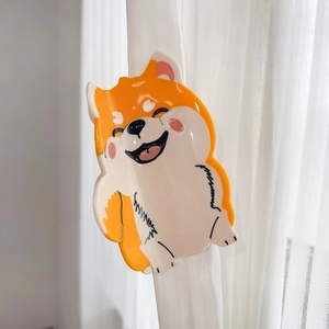 Cute Shiba Inu patterned acetate hair claw clip styling accessory on white sheer curtain