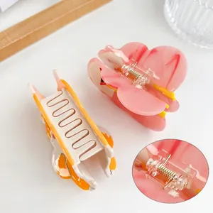 Elegant acetate butterfly hair claws with protective spring sleeves for secure styling