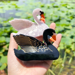 Elegant swan-shaped acetate hair claws in black and marble pink for women