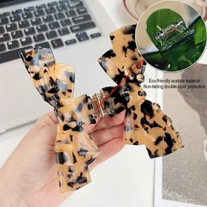 Acetate tortoise shell bow hair claw clip for women with strong metal spring detail