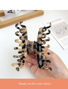 Detail of tortoise shell acetate hair claw clip with double row teeth for firm grip