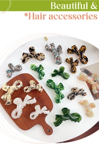 Detailed view of acetic acid bow hair claws in tortoiseshell and marble patterns