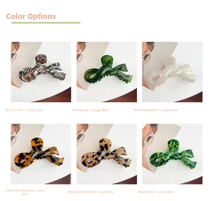 Detail showcasing six colorful large acetate bow hair claws in various marble patterns