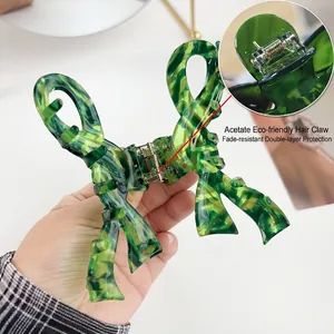 Elegant green marble acetate bow hair claw clip with durable double-layered gold spring