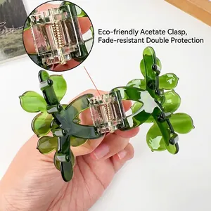 Pince à cheveux en acétate vert foncé en forme de fleur et feuille avec strass