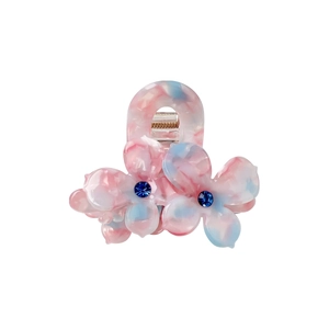 Pince à cheveux en acétate avec motif marbré rose bleu et strass bleus brillants