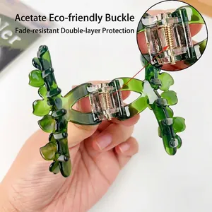 Deep green leaf acetate hair claw clip with crystal accents for women's hairstyling