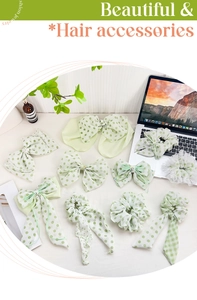 Detailed close-up of light green floral organza hair scrunchies and bow hairpins set