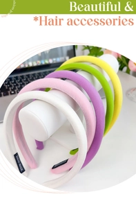 Detail of five colorful sponge headbands in white pink purple green and yellow sets