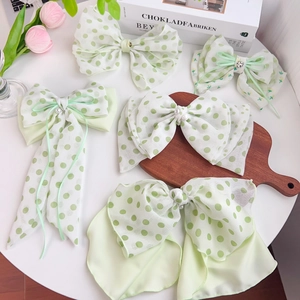 Pastel green fabric hair scrunchies with floral and polka dot patterns set for women