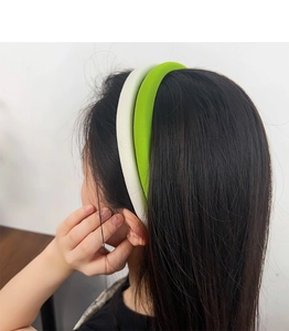 Detail view of thick green sponge headband on model for high cranial top effect