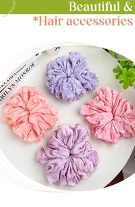 Close-up of large ruffled fabric scrunchies with soft bubble texture in pastel colors