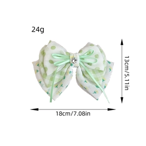 Floral bow hair clip with green polka dots, plaid patterns and a heart rhinestone center