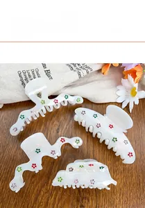 Detailed set of white pearlescent acetate hair claws with colorful floral patterns