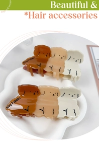 Close-up of three cute teddy dog acrylic hair claws in gradient brown and beige tones