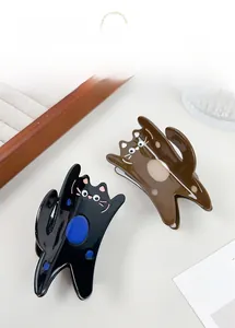 Detail of cute cat claw clips in black and brown acetate with a glossy finish