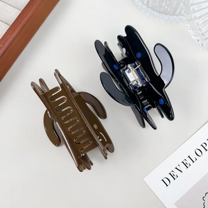 Minimalist acetate hair claws in black and coffee brown with a glossy finish for women