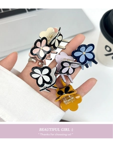 Close-up of colorful clover hair clips with acetate finish and sparkling crystal center