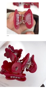 Detail of handmade burgundy hair claw clip with golden metal spring and smooth finish