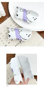 Detail of cute white and purple puppy hair claw clip showing spring mechanism and acetate texture