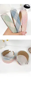 Close-up of padded plaid headbands in various colors with soft fabric texture