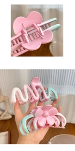 Detail of macaron gradient hair claw clip showing spring mechanism and butterfly shape