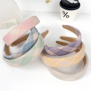 Set of six colorful plaid padded headbands in soft pastel tones on white background