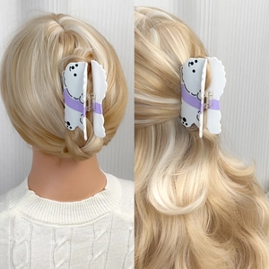Large cloud-shaped dog hair claw clip for women shown on blonde curly hair