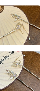Close-up of golden tassel hair sticks with butterfly motifs and pink gemstones for Hanfu