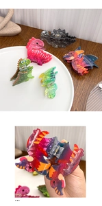 Macro detail of acrylic dinosaur hair claw clips showing texture and spring mechanism