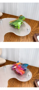 Detail of dinosaur hair claw clips in green and purple marble textured acrylic