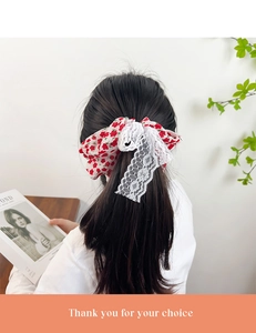 Detail view of floral print hair scrunchie with white lace on a ponytail hairstyle