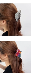 Close-up of marble pattern dinosaur hair claw clip securing a bun on model hair