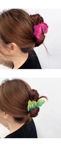 Detail view of colorful acrylic dinosaur hair claws for stylish women hair accessories