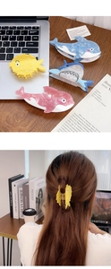 Detailed view of ocean-themed shark and dolphin acetate hair claws in various vibrant colors