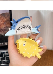 Detail of cute shark and pufferfish hair claws made of premium glossy acetate material