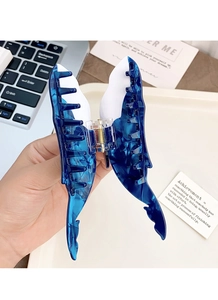 Detailed view of ocean-style butterfly hair claw clip with blue and white acetate finish