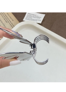 Close-up of a silver butterfly claw clip with metallic luster and parallel teeth