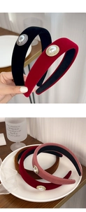 Detailed macro view of retro velvet headband with elegant faux pearl and golden trim