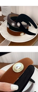 Detail of velvet headbands with elegant pearl and metal embossed side ornaments