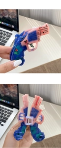 Detailed view of the pistol-shaped hair claw clip with pink and blue marble texture