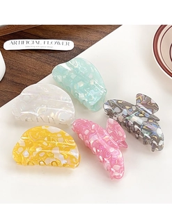 Collection of colorful acetate hair claws with iridescent marble textures and shell finish